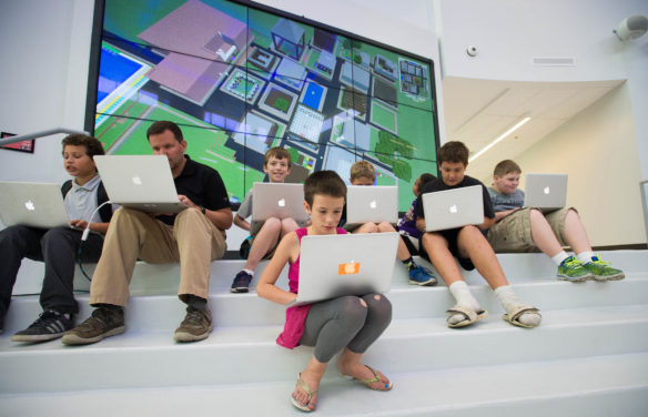 Neshawna Whitehouse, center, and her classmates play Minecraft with James Allen as part of a class in the schools' new Ed Hub. Photo by Bobby Ellis, Sept. 15, 2016