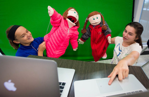 Cloe Stivers, left, and Kassidy Allen use puppets to film a PSA video about avalanche safety. Photo by Bobby Ellis, Sept. 15, 2016