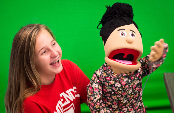 Heidi Adams practices her script with her puppet while working on a video project in Eminence Junior/Senior High School's new Ed Hub.