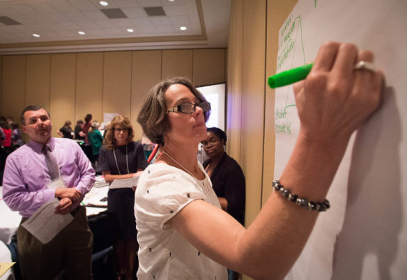 Kathy House, chief academic officer of Trimble County Schools, writes different strategies to help with novice reduction during a session at the 2016 Kentucky Continuous Improvement Summit in Lexington. Photo by Bobby Ellis, Sept. 20, 2016