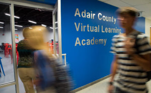 Adair County High School students walk past the school's Virtual Learning Academy between classes. The storefront-like entrance is part of an effort to make what was once a storage area more inviting to students as a place to study. Photo by Bobby Ellis, Sept. 26, 2016