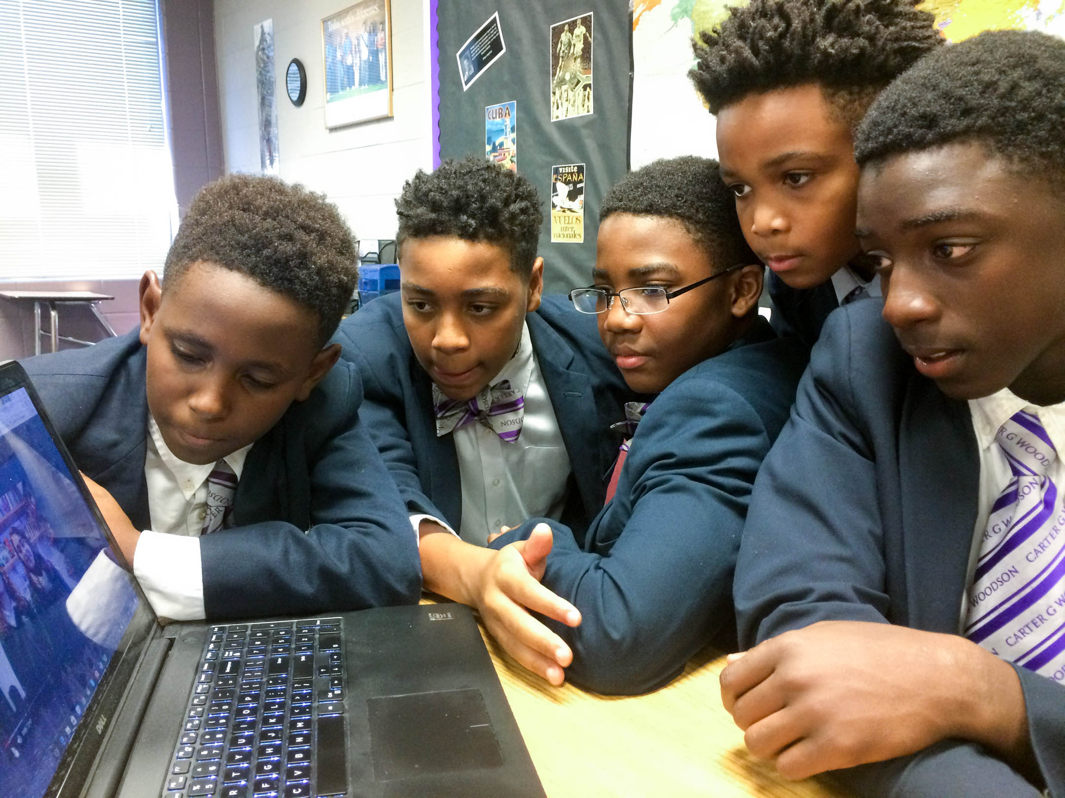 Carter G. Woodson Academy (Fayette County) 7th-grade Spanish students, from left, Elijah Maupins Floyd, Caden Johnson, Joseph Edmonds, Maxwell Clay and Xavier Brown connect virtually with San Viator School in Madrid, Spain. Photo by Ben McMaine