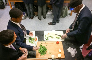 Carter G. Woodson Academy 7th-grade Spanish students, from left, Marcus Jones, William Holmes and Justin Graves prepare salsa picante, investigating cultural practices through collaboration between science and Spanish classes. Submitted photo by Ben McMaine