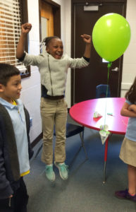Third-graders get excited after successfully getting a balloon to flink, neither float nor sink, while discovering the principles of gravity. This lesson came from PBS Kids Zoom! Submitted photo by Erin Bloomer