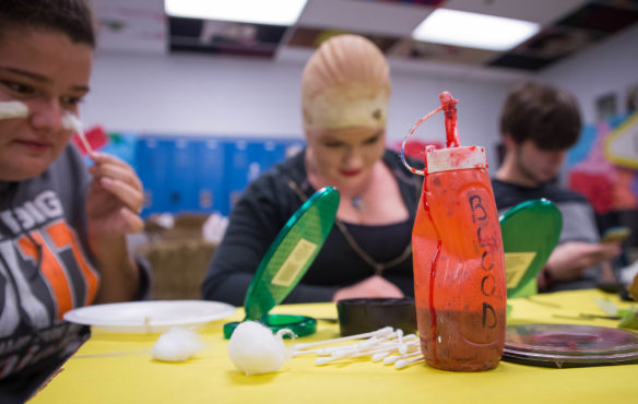 A bottle of fake blood sits on a table as students at Lynn Camp High School prepare for senior class haunted trail. Photo by Bobby Ellis, Oct. 14, 2016