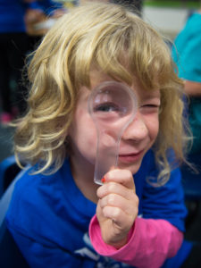 Lucy Jennings, a 2nd-grader at Moyer Elementary (Ft. Thomas Independent) holds up a magnifying glass during class. Photo by Bobby Ellis, Oct. 20, 2016