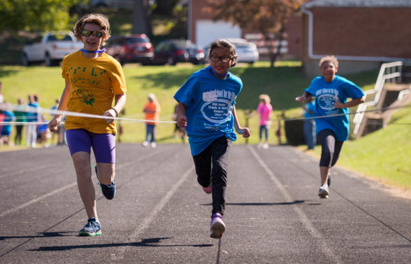 Sophia Thompson, center, runs in the 30 meter race at the 2016 Bill Roby Track and Field Games at the Kentucky School for the Blind. Photo by Bobby Ellis; Oct. 12, 2016