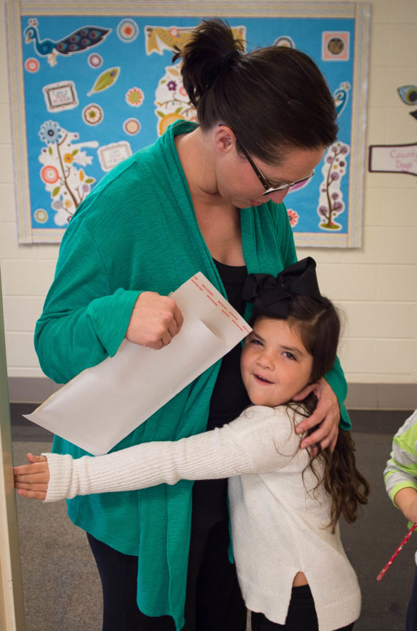 Johnson Elementary School Principal Jamie Gilliam gets a hug from Laylee Phillips between classes at the Laurel County school, which was named a 2016 National Blue Ribbon School. Gilliam is in her second year at the school, which has fewer than 300 students and about 25 teachers and staff members. Photo by Bobby Ellis, Nov. 18, 2016