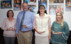 Four staff members from Pulaski County schools were recently given the district's PRISM Award, which recognizes staff members who have demonstrated innovative techniques and strategies that support student success and welfare. Recipients are (left to right) Kathy Molen, Oak Hill Elementary School; Doug Grider, Southwestern High School; Jeannie Smith, Northern Middle School; and Courtney Frye, Nancy Elementary School. Photo submitted