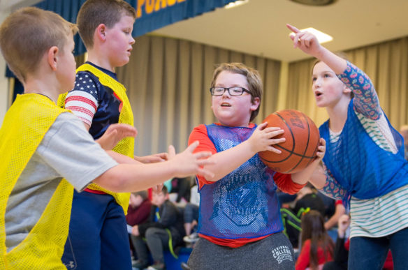 Pogue Elementary School (Ashland Independent) students Laura Beth Stanfield, right, tells Aiden Johnson to shoot the ball during a game of noonball. In the game, which was created by a former principal at the school, every player on the team gets a chance to shoot the ball. Photo by Bobby Ellis, Nov. 29, 2016