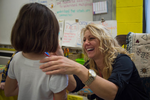 Kim Setty, a 2nd-grade teacher at Mary Goetz Elementary (Ludlow Independent) wipes the nose of a student during class. Setty and a group of northern Kentucky teachers are working to make the transition between districts easier for highly mobile students in the area. Photo by Bobby Ellis, Dec. 2, 2016