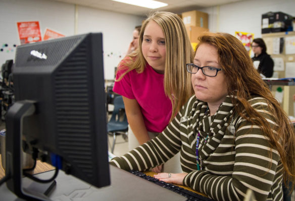 Emily Vickers, a 7-th grader at Foley Middle School (Madison County) helps Brittany Freel, a 7-th grade math and social studies teacher, with coding a game during the Hour of Code. Photo by Bobby Ellis, Dec. 7, 2016