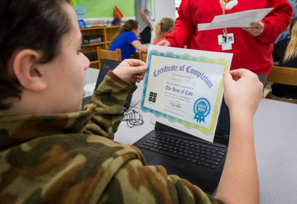Hayden Henry, a 7th-grader at Foley Middle Schoola 7th-grader at Foley Middle School, gets a certificate of completion for taking part in the Hour of Code. Photo by Bobby Ellis, Dec. 7 2016