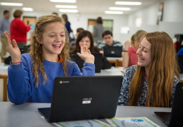 Aubrey Crabtree, a 7th-grader from Foley Middle School, and Maddey Stringfield react as Crabtree attempts to code a game. Photo by Bobby Ellis, Dec. 7, 2016