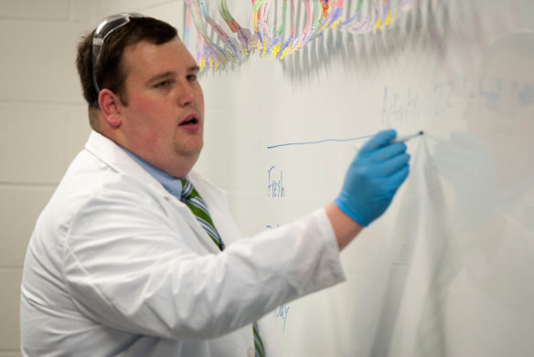 Jacob Ball, an agriculture instructor at Locust Trace Agriscience Center (Fayette), writes instructions on a board during one of his agriculture science classes. Ball was awarded the 2017 New Teacher of the Year award by the Association for Career and Technical Education. Photo by Bobby Ellis, Jan. 17, 2017