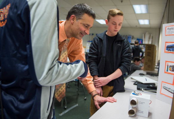 Gray Middle School Principal Todd Novak listens to a presentation from 7th-grader Jayden Wren during Project Lead the Way (PLTW) class about energy and the environment. Every student the school takes three PLTW classes before high school. Photo by Bobby Ellis, Jan. 24, 2017