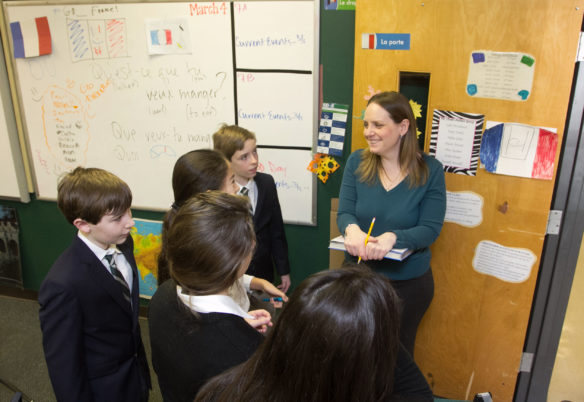 Sixth-grade students at The Lexington School complete an exit interview with teacher Sara Merideth before leaving class. Merideth says the goal of using a foreign language for 90 percent of classroom time, one of the Six Core Practices of American Council on the Teaching of Foreign Languages, shouldn't scare educators. Submitted photo by Mick Jeffries