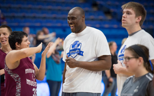 Marquis Estill, center, jokes with Special Olympics athletes during the skills clinic portion of the night. Former University of Kentucky players ran through shooting drills, ball handling and defense with Special Olympics athletes during the night. Photo by Bobby Ellis, Feb. 21, 2017