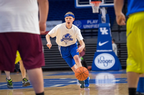 Special Olympics athlete Ryan Barts, of Georgetown, dribbles down the court during the combined Special Olympics and Unified sports blue and white game at Rupp Arena. Special Olympics athletes got to play against former University of Kentucky players and take part in a skills clinic. Photo by Bobby Ellis, Feb. 21, 2017