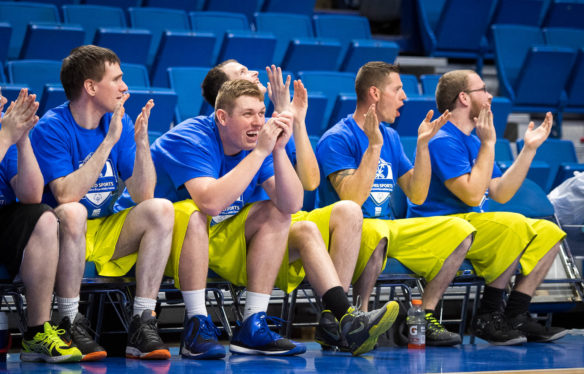 Special Olympics athletes cheer from the bench after their team scored a basket during the Special Olympics and Unified Athletes game at Rupp Arena. Photo by Bobby Ellis, Feb. 21, 2017