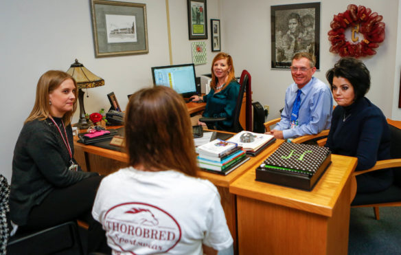 A Harrison County High School student meets with, from left, Counselor Allison Earlywine, Assistant Principal Jenny Nichols, Director of Pupil Personnel Bow Switzer and Chief Academic Officer Jenny Lynn Hatter. Students who are considering leaving school meet with committees tailored to them as part of the district's effort to help students persist to graduation. Photo by Mike Marsee, Dec. 13, 2016