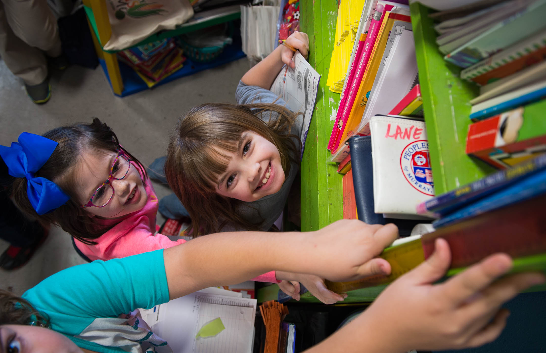 Isabella Norsworthy, left, and Reagan Beavers, 2nd-graders at Southwest Calloway Elementary, measure a bookcase during an activity in their kindergarten class. The faculty at the school uses data to measure where their students stand and to plan instruction. Photo by Bobby Ellis, Dec. 8, 2016