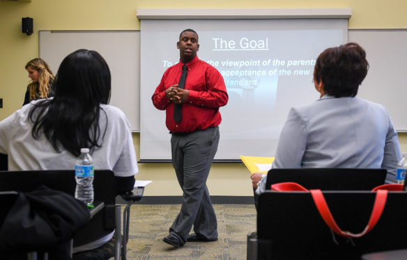 Michael Biggers, a junior from Seneca High School (Jefferson County), and his partner, junior Kali Riggs, present to judges at the Educators Rising conference about ethical dilemmas teachers might face. For the competition, students were asked to explain how they would handle parents disagreeing with new teaching standards at schools. Kentucky recently formed a state chapter of Educators Rising in hopes of encouraging more students to pursue careers in education. Photo by Bobby Ellis, March 11, 2017