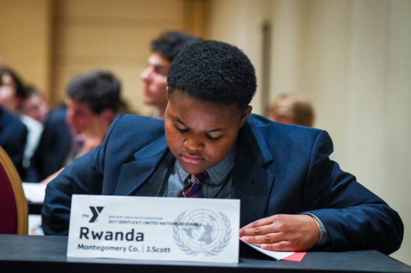 J. Scott, a freshman at Montgomery County High School, reads through a proposal while representing Rwanda in the General Assembly at the Kentucky United Nations Assembly. Photo by Bobby Ellis, March 13, 2017