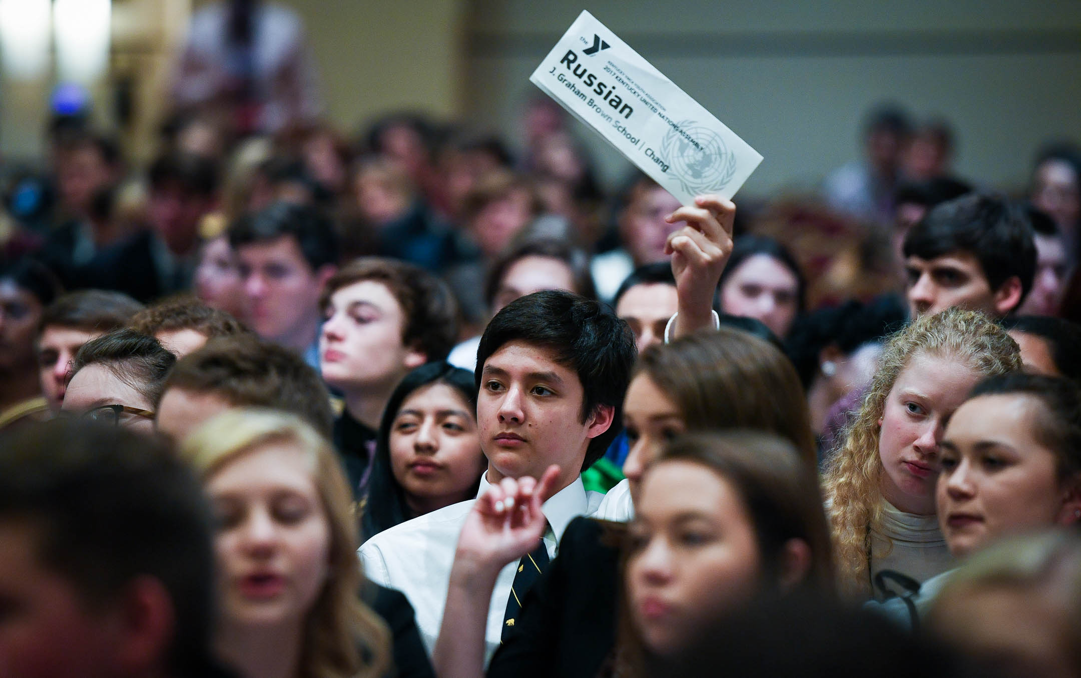 Sovann Chang, a junior at J. Graham Brown School (Jefferson County), votes on a proposal while representing Russia in the KUNA General Assembly. Students studied other nation's culture along with their political views for around six months in preparation for KUNA. Photo by Bobby Ellis, March 13, 2017