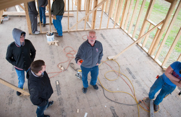 Garlen Whitis gives instructions to his students who are working on a tiny house. Whitis' classes have been building houses for the past 14 years, but this was the first year they decided to build a tiny house. Photo by Bobby Ellis, Feb. 3, 2017