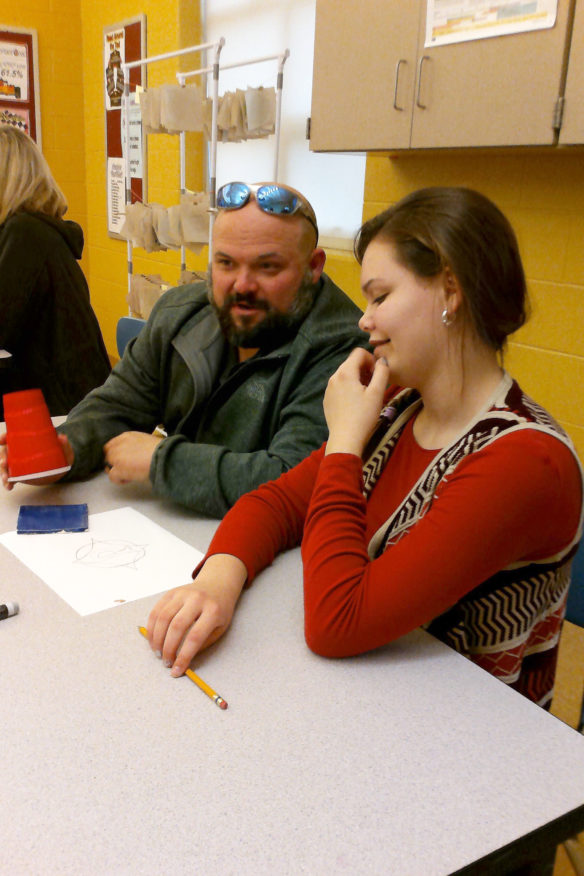 Andrew Perry and his daughter Alexandria, a 7th-grade student at Maurice Bowling Middle School (Owen County) work on the Leader in Me mosaic created by students and family members during a family night at the school. Submitted photo by Anderson Sunda