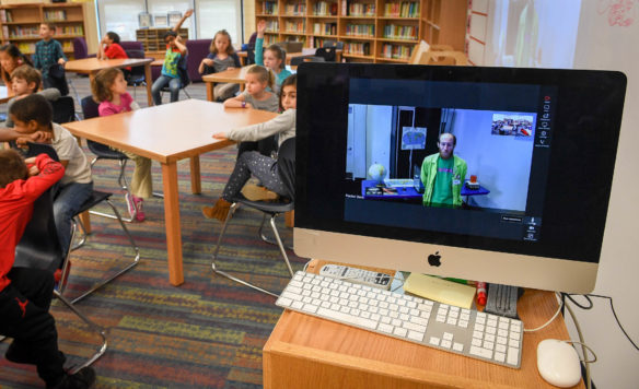 Brian Morris, a member of the education staff at the Kentucky Science Center, speaks to 1st-grade students at Lowe Elementary School from the center using a video conferencing system. The center's distance learning programs include two or three interactions with a class using a video conferencing platform that allows it to connect with any existing technology in schools. Photo by Bobby Ellis, March 14, 2017