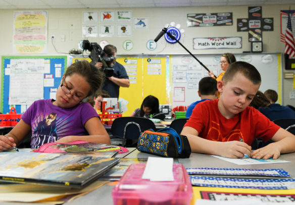 Neveah VanCleave, left, and Grayson Brown work on flip-books as their 2nd-grade class if filmed by KET for its form and assessment videos. Photo by Bobby Ellis, March 21, 2017