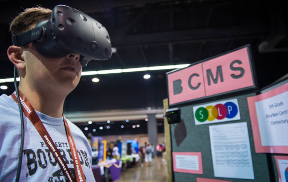 Jake Enmen, an 8th-grader at Bourbon County Middle School, demonstrates a pair of virtual reality goggles used to explore a 3D model of Bourbon County Middle School that he made as his STLP project.