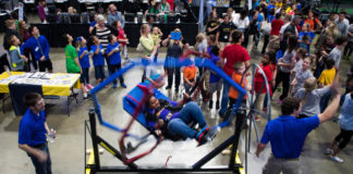 Mya Webb, a 5th-grader at John G. Carlisle Elementary (Covington Independent) rides in a gyroscopic chair at the STLP State Championship while others wait their turn. Photo by Bobby Ellis, April 12, 2017