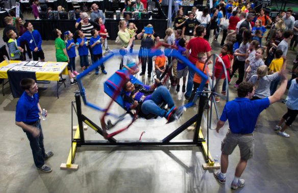 Mya Webb, a 5th-grader at John G. Carlisle Elementary (Covington Independent) rides in a gyroscopic chair at the STLP State Championship while others wait their turn.<br srcset=
