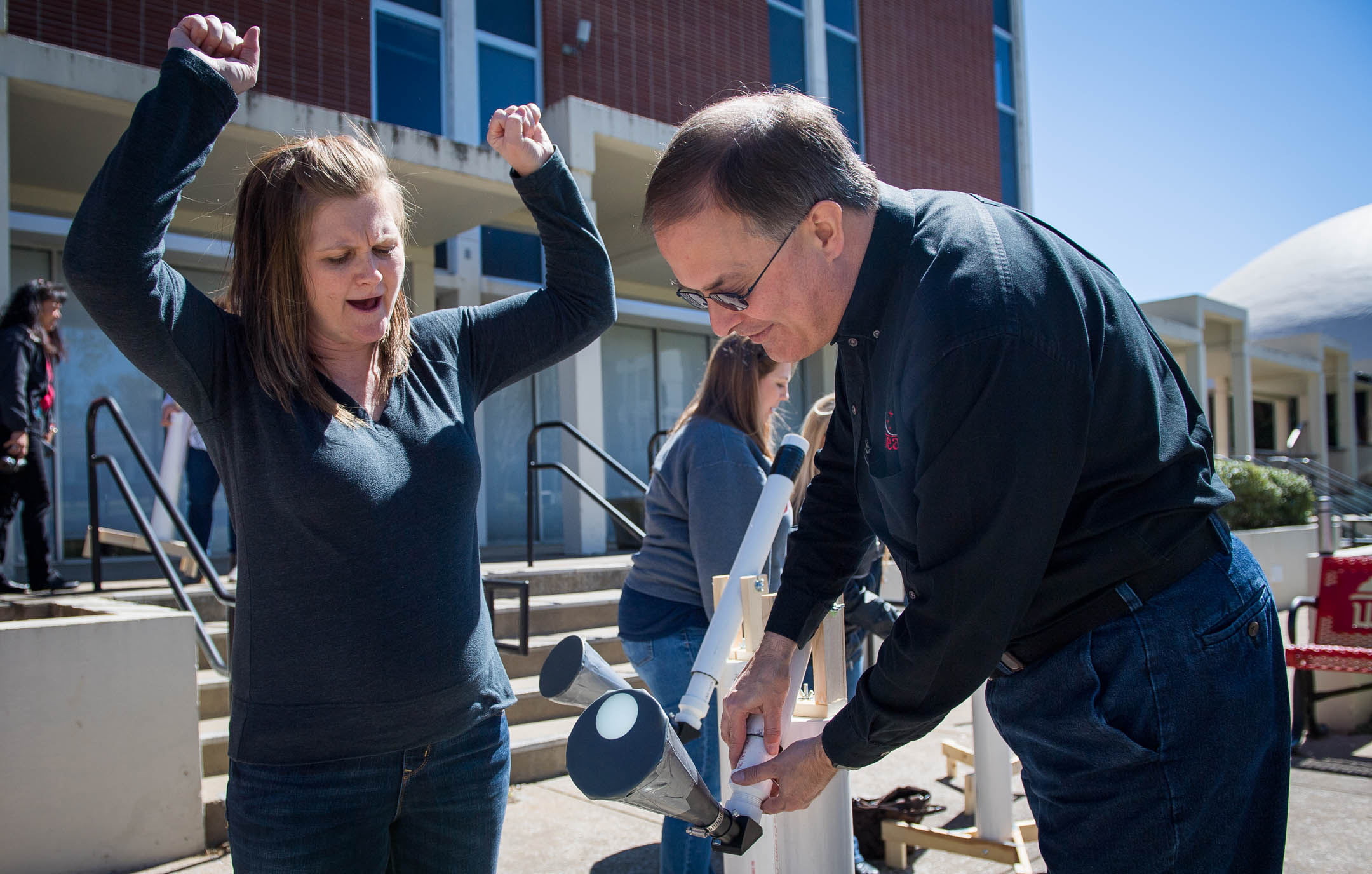 April Craft, an 8th-grade science teacher at James E. Bazzell Middle School (Allen County), celebrates as Rico Tyler, a master teacher in Western Kentucky University's SKyTeach program, helps set up her homemade telescope to view the sun during a solar science workshop at WKU. The workshop was designed to help teachers use the Aug. 21 total solar eclipse as a teaching opportunity. Photo by Bobby Ellis, April 7, 2017
