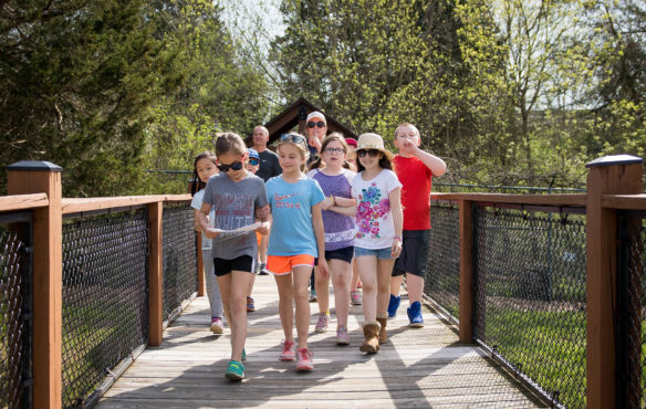 Fourth-grade students from Western Elementary (Scott County) walk to the deer enclosure during a field trip to Salato Wildlife Center in Frankfort. The center houses deer, bison, elk, bobcats and other animals native to Kentucky.  Photo by Bobby Ellis, April 14, 2017
