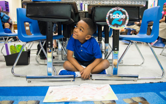 Jackson White, a 1st-grader at Schaffner Traditional Elementary, reads a book under a desk during literacy center time in Sarah Dickinson's class. The Jefferson County school was one of five Kentucky public schools to be named at 2016 National Blue Ribbon winner. Photo by Bobby Ellis, April 18, 2017