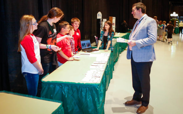 Alyssa Deshon, second from left, a 6th-grade student at Lincoln County Middle School, and other members environmental team explain their work to Commissioner of Education Stephen Pruitt prior to the awards luncheon. Photo by Mike Marsee, April 27, 2017