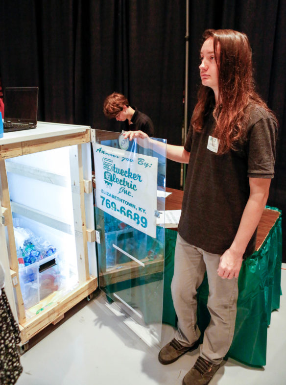 Gabe Oelschlager, a junior at the Early College and Career Center (Hardin County) displays the interior of the recycling device created by students in the school's energy management program. Photo by Mike Marsee, April 27, 2017