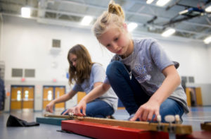 Emma Wolfe, a 4th-grader at Walton-Verona Elementary School (Walton Verona Independent), practices with a cardboard dulcimer during practice for the school's Swingin' Dulcimer group.