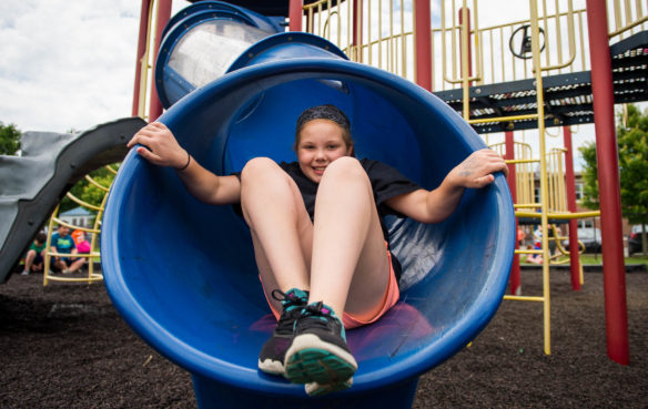 Caylee Frederick goes down a slide as part of an obstacle course during the field day events on the last day of school at Taylorsville Elementary.