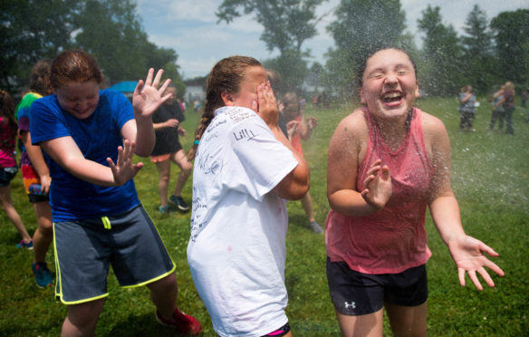 A group of Taylorsville Elementary 6-th graders are sprayed with a hose during the end of the year field day on the last day of school. Photo by Bobby Ellis, May 23, 2017