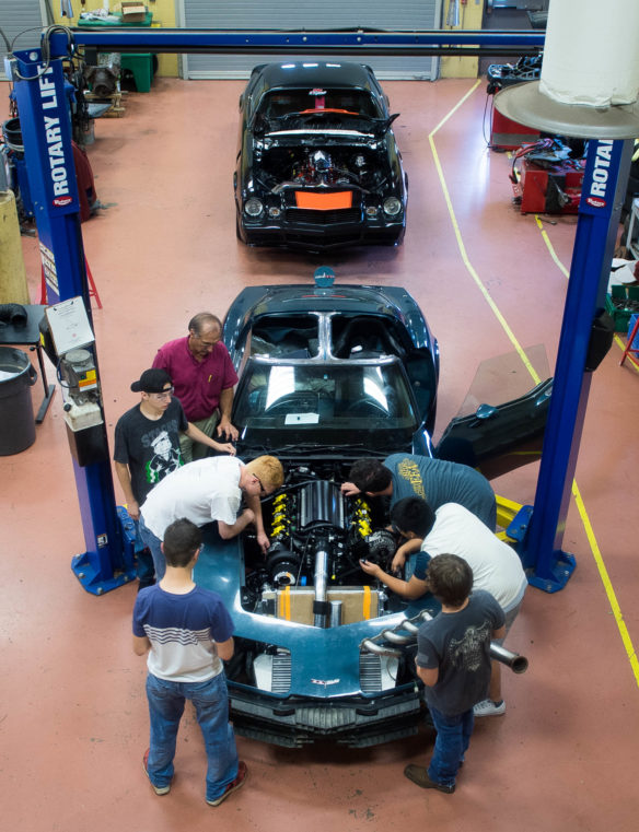 Warren County Area Technology Center students work on a custom 1980 Corvette as automotive instructor Michael Emberton, back, looks on. The car is being rebuilt as part of the On Track motorsports education initiative, which seeks to address the growing need for skilled workers in the automotive sector in southcentral Kentucky. Photo by Bobby Ellis, May 11, 2017