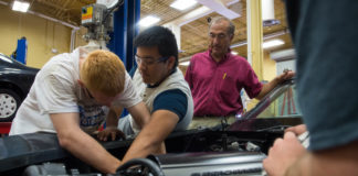 Warren County ATC automotive instructor Michael Emberton watches as students Jacob Whitson, left, and Freddy Hernandez work on the Corvette. The students and their car are competing against students from South Central Kentucky Community and Technical College as part of the On Track program. Photo by Bobby Ellis, May 11, 2017