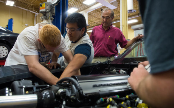 Warren County ATC automotive instructor Michael Emberton watches as students Jacob Whitson, left, and Freddy Hernandez work on the Corvette. The students and their car are competing against students from South Central Kentucky Community and Technical College as part of the On Track program. Photo by Bobby Ellis, May 11, 2017