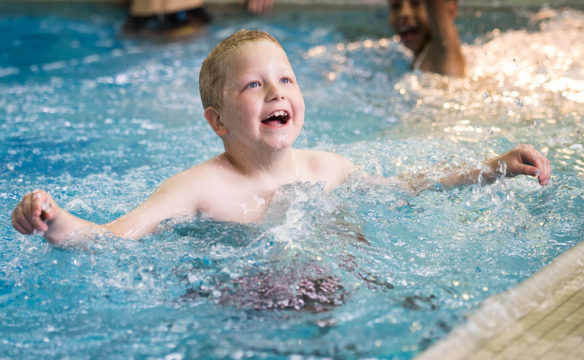 Jacob Collins, an elementary student at the Kentucky School for the Deaf, swims in the school's pool during the last day for students.<br srcset=