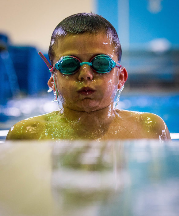 Matthew Colbert emerges from the pool after jumping in during the elementary pool day at the Kentucky School for the Deaf.<br srcset=