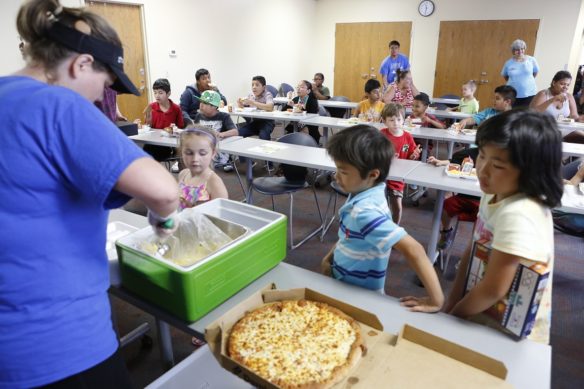 Kids line up at the Village Branch of the Lexington Public Library for a free meal provided through the Summer Food Service Program. The program offers more than 2,000 school and community sponsored feeding sites across Kentucky this summer for children 18 and under. Photo by Mike Marsee, June 15, 2017